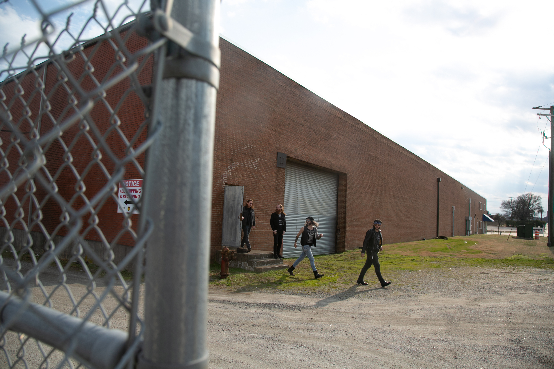 U.S. Bastards outside a brick warehouse